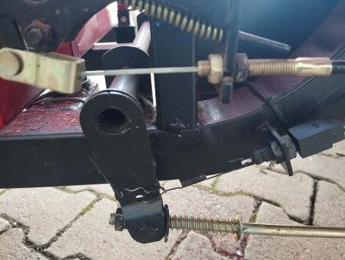 rechts mitte der Bremslichtschalter mit 2x Muttern SW16 aus Kunststoff, mit schwarzer dünner Zugfeder AØ7x78mm Draht Ø0,85mm